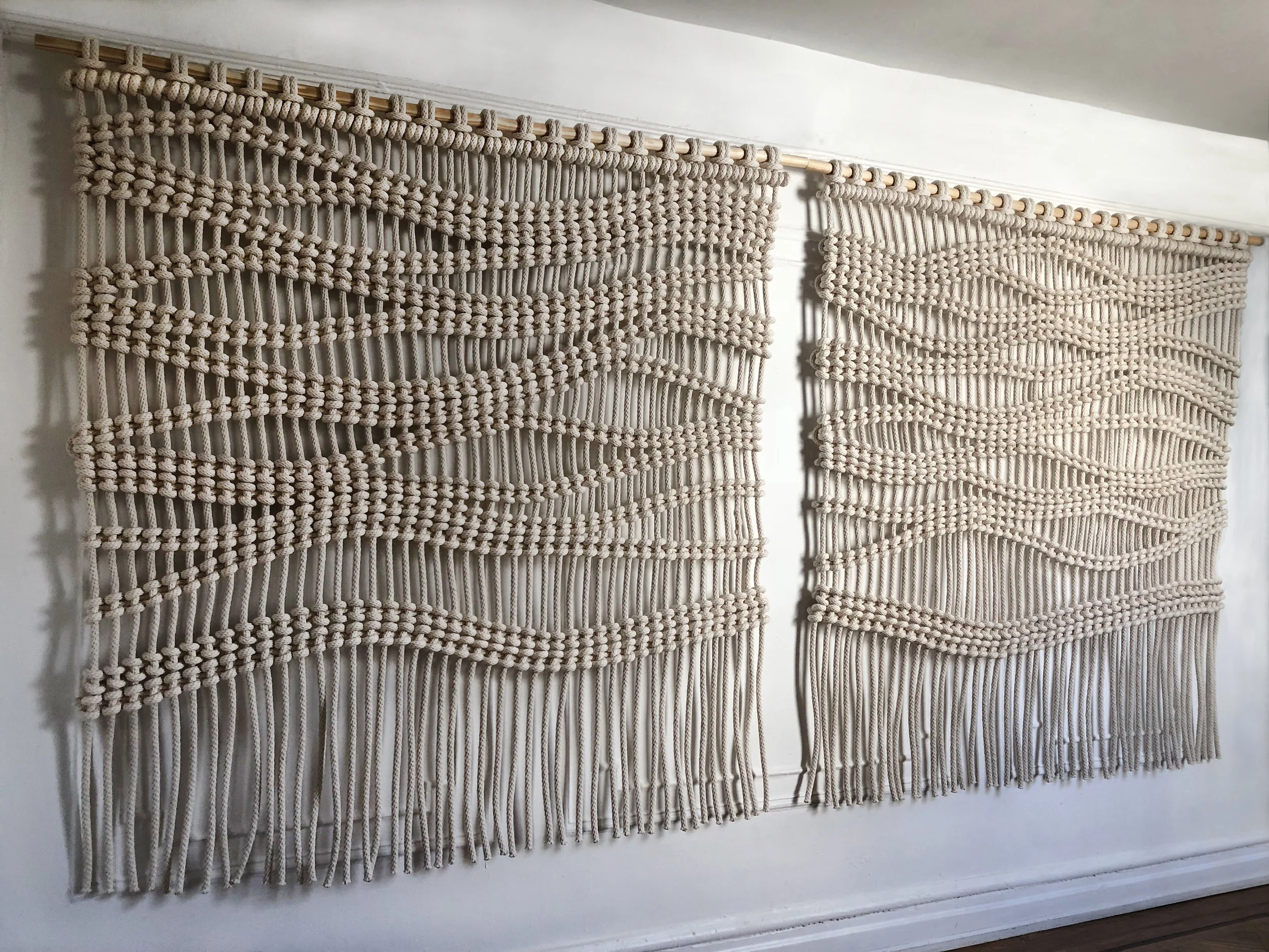 READY TO SHIP - $4000 PAIR - PLEASE USE CONTACT FORM FOR PURCHASE. LARGE SCALE WAVE MACRAME ROOM DIVIDERS. A SET OF MACRAME WAVE PATTERN WALL HANGING - ROOM DIVIDERS MADE FROM THICK ORGANIC COTTON ROPE. EACH HANGING MEASURES 6 FEET WIDE X 6 FEET HIGH.