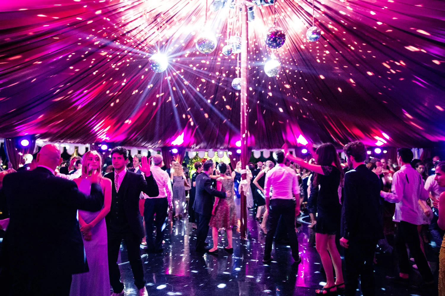 VAN WYCK The after part tent glows in pink lighting at a wedding in Tuscany.