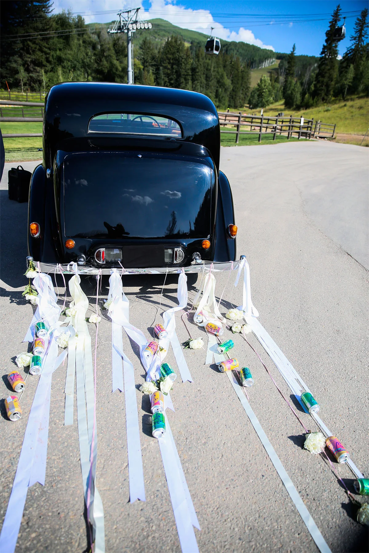 VAN WYCK An antique car decorated for the getaway at a mountaintop wedding in Vail, CO.