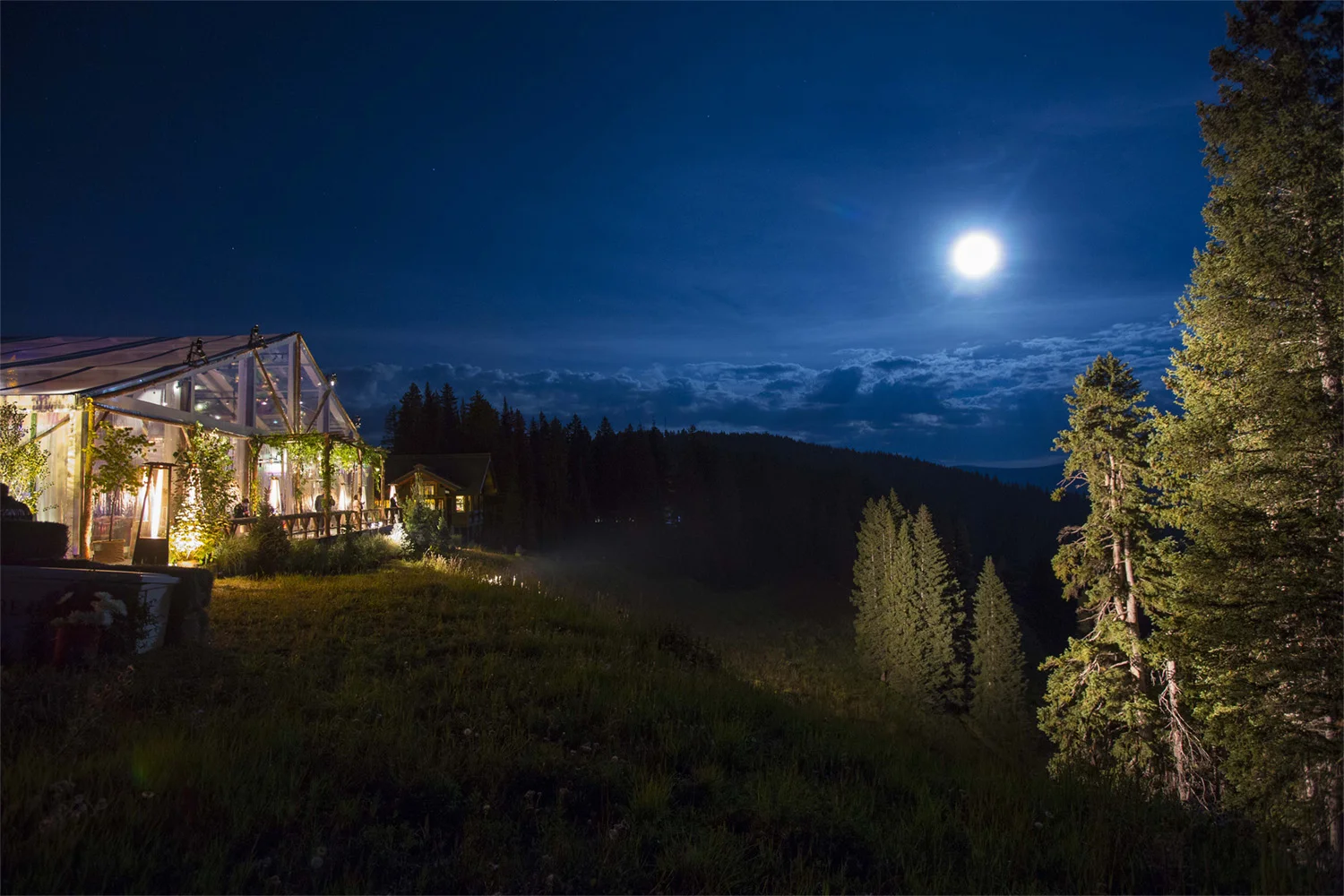 VAN WYCK A wedding tent glows under a full moon at a mountaintop wedding in Vail, CO.