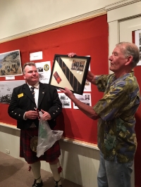 Ron Dunne, Official Historian of The Caledonian Club of San Francisco, presented Society Director Jim Muldoon with the Club's Tartan as a memento of the evening and the Club's pivotal role in the 1868 naming of Caledonia Street.