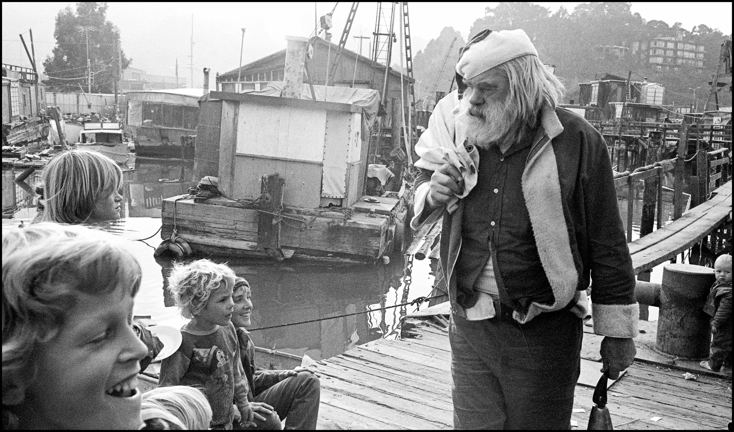 Santa (AKA Frank Anderson) visits the docks in the 70s in this image from Bruce’s book. Anderson was a local character who owned a nursery on Bridgeway. ©Bruce Forrester