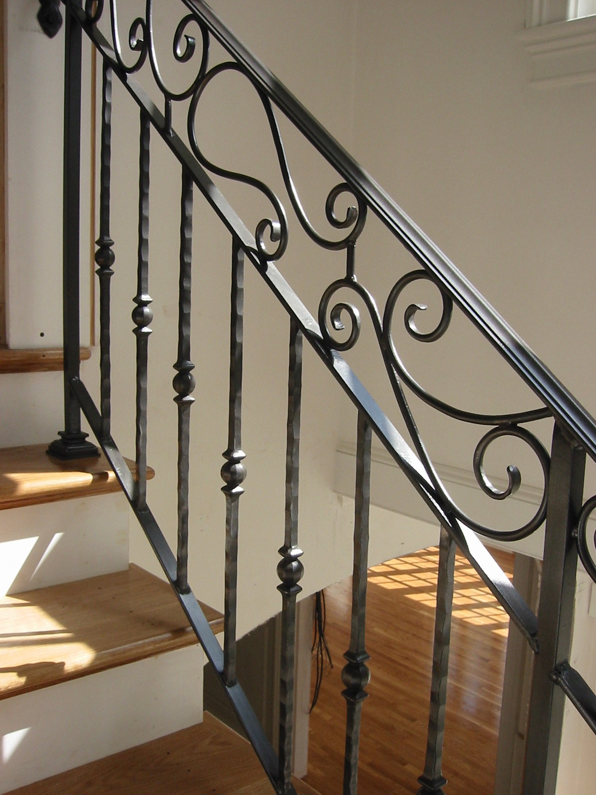 Interior Scrolled Railing with Cast Pickets. Hand-Rubbed Finish.