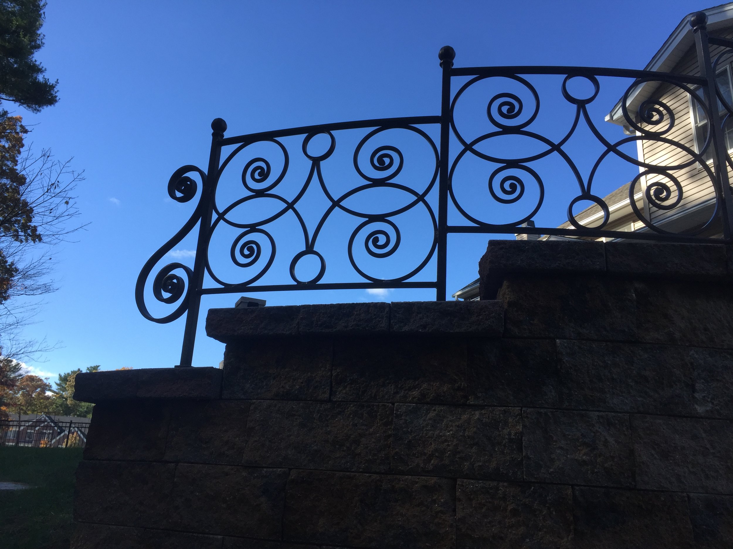 Hand-forged fencing on a retaining wall