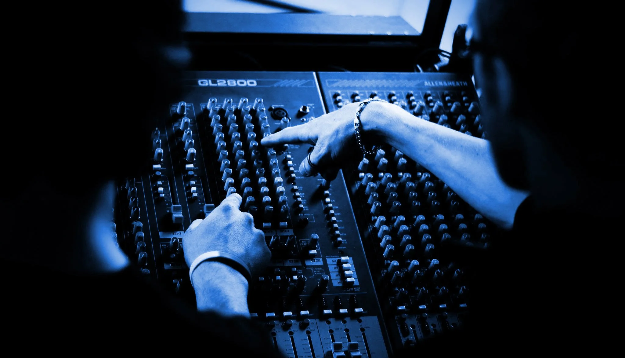 1stintheatre instructor with a student demonstrating how to use a Sound Desk