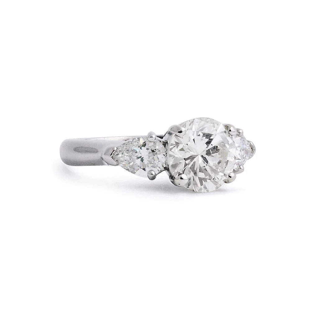 Round Brilliant Solitaire Engagement Ring With Pear Shaped Side Stones