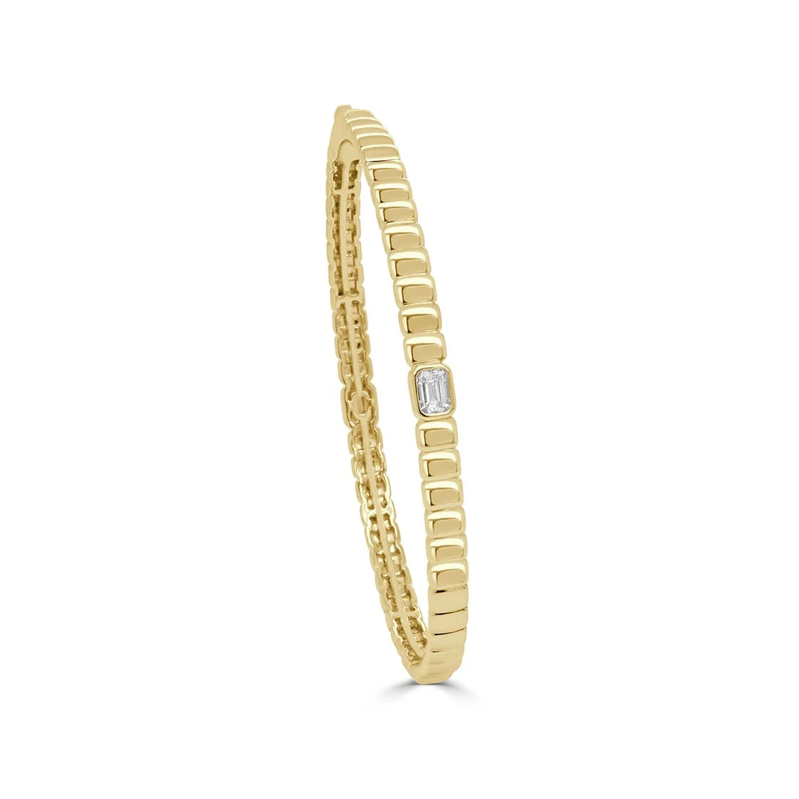 Angled view of a 14K yellow gold emerald cut diamond bangle with polished articulated design.