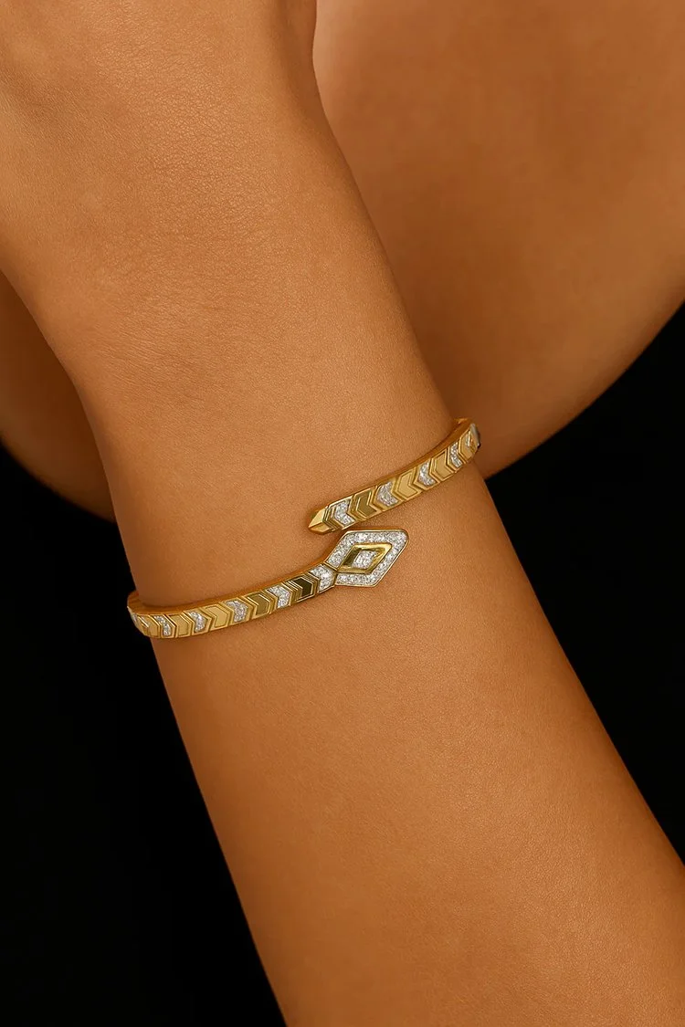 Model wearing a 14K yellow gold diamond snake bangle with pavé detailing and sculptural design. (Copy)