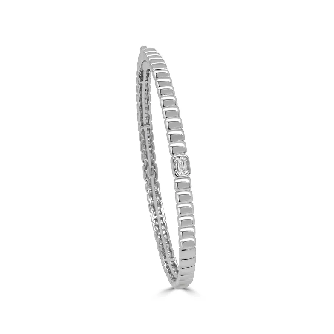 Angled view of a 14K white gold emerald cut diamond bangle with polished articulated design.