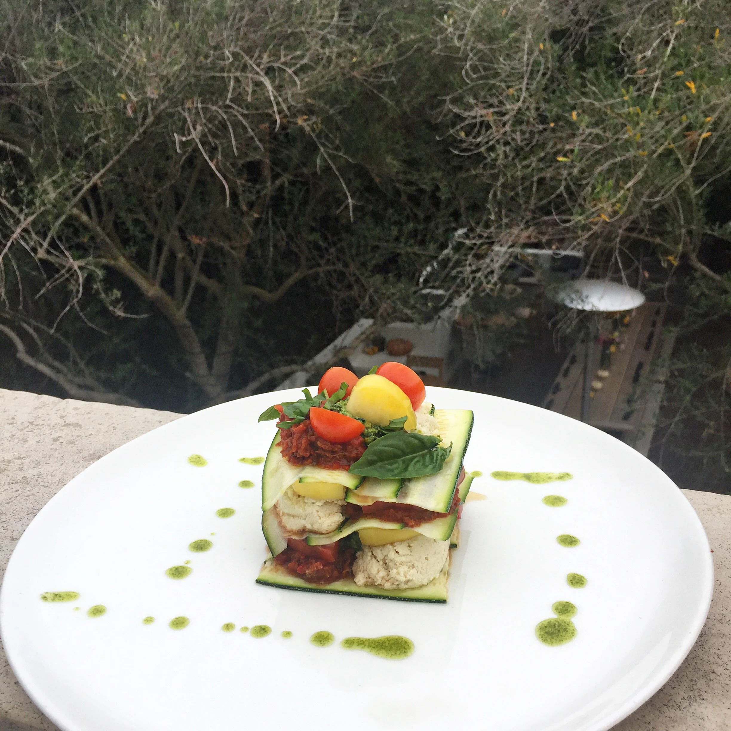 Raw vegan Zucchini Lasagna with Macadamia Ricotta, Red Pepper-Sundried Tomato Marinara, and Pistachio Pesto. 