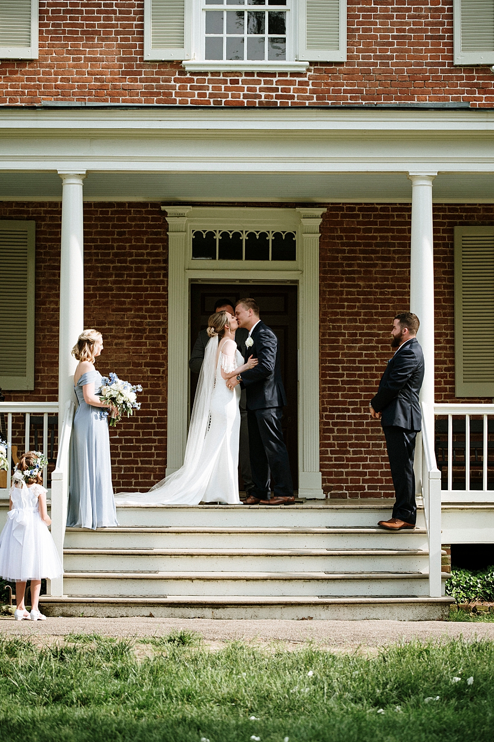  Southern bride and groom sharing their first kiss as husband and wife outside the beautiful manor house at Locust Grove in Louisville Kentucky. spring wedding ceremony Locust Grove Louisville photographer Kentucky wedding photography by Lauren outdo