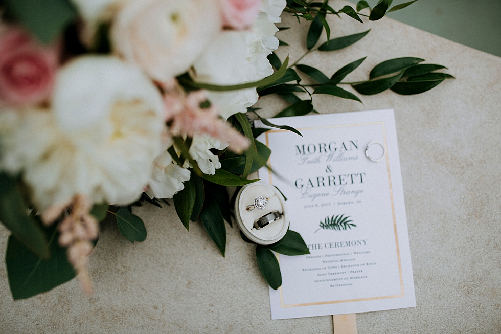  Gorgeous handpicked bouquet alongside wedding announcement and rings at Huber’s orchard and winery in Louisville Kentucky. Huber’s orchard and winery spring wedding Louisville Kentucky wedding photography by Lauren outdoor wedding ceremony bride and