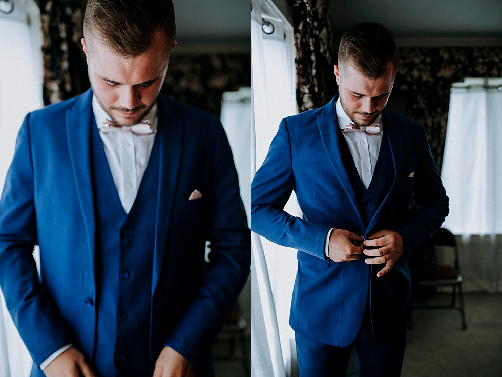  Dapper groom in a royal blue three-piece suit sporting a blush pink bowtie at Huber’s orchard and winery in Louisville Kentucky. Huber’s orchard and winery spring wedding Louisville Kentucky wedding photography by Lauren outdoor wedding ceremony sou