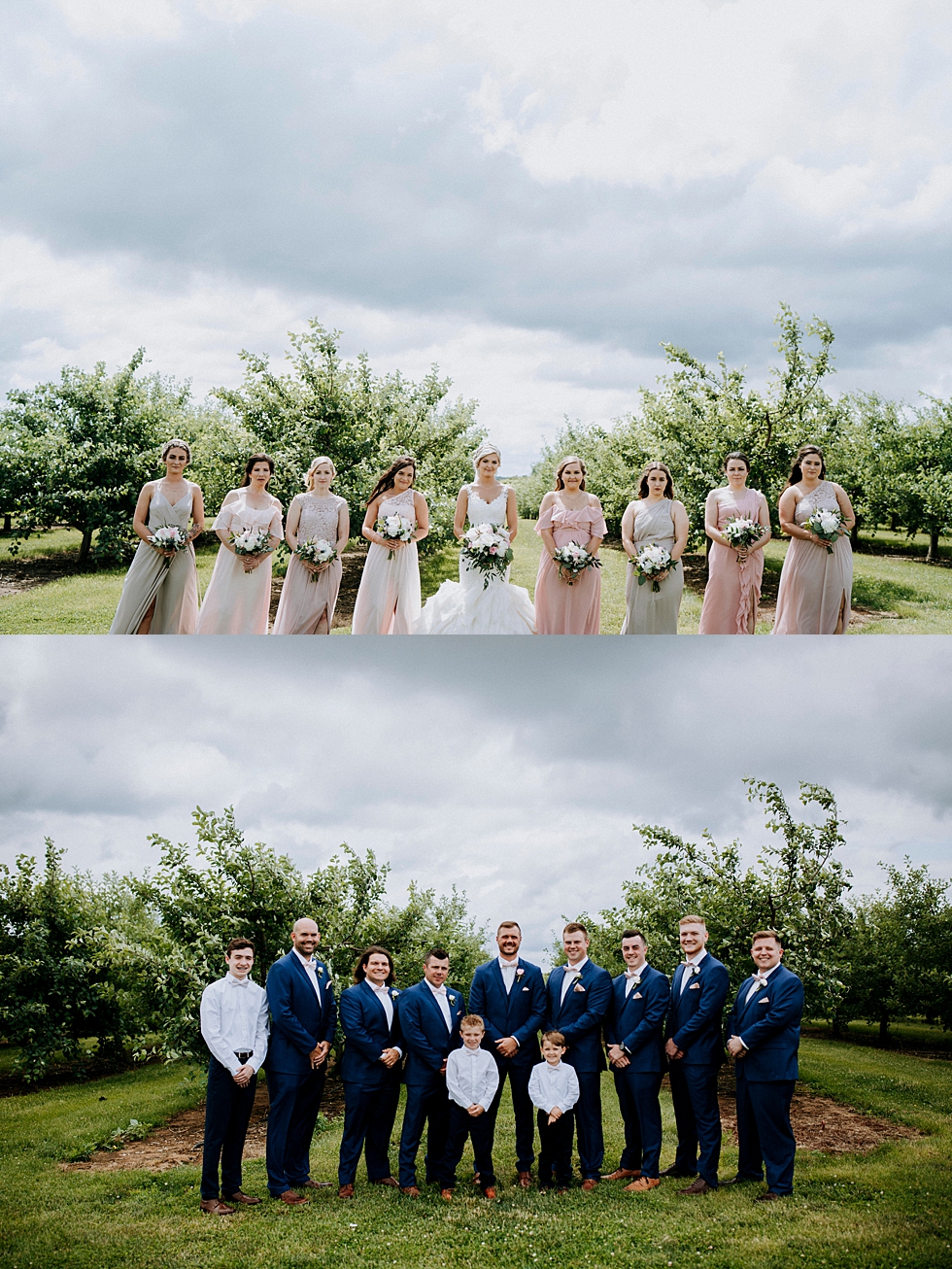  Stunning bridesmaids and groomsmen alongside the bride and groom on their special day at Huber’s orchard and winery in Louisville Kentucky. Huber’s orchard and winery spring wedding Louisville Kentucky wedding photography by Lauren outdoor wedding c