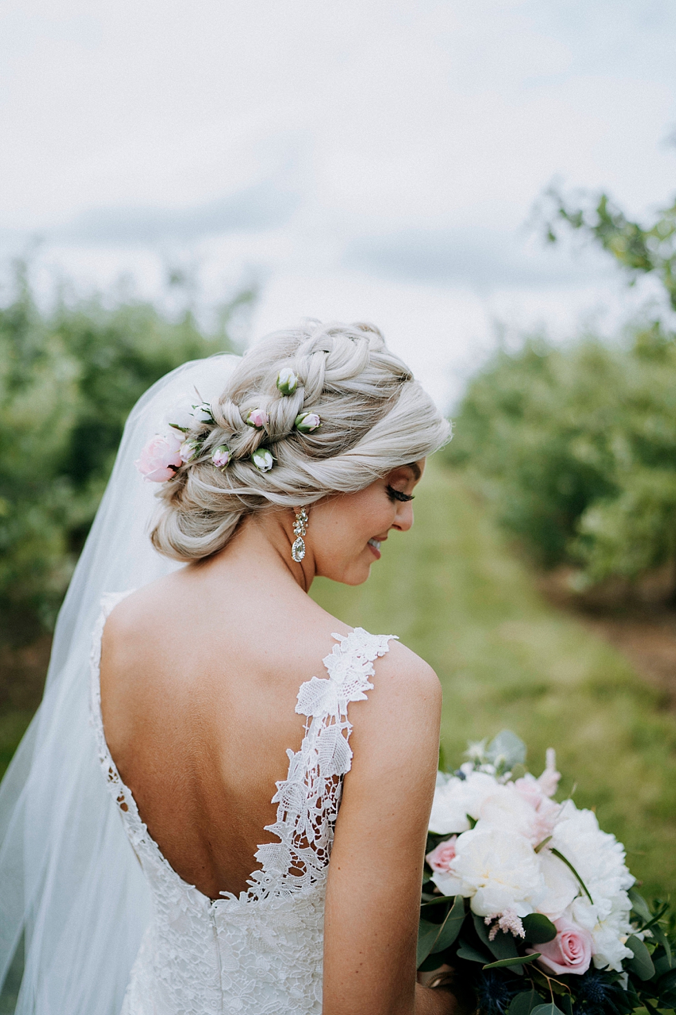  Stunning bridal hair with rose accents at this outdoor wedding at Huber’s orchard and winery in Louisville Kentucky. Huber’s orchard and winery spring wedding Louisville Kentucky wedding photography by Lauren outdoor wedding ceremony bride and groom