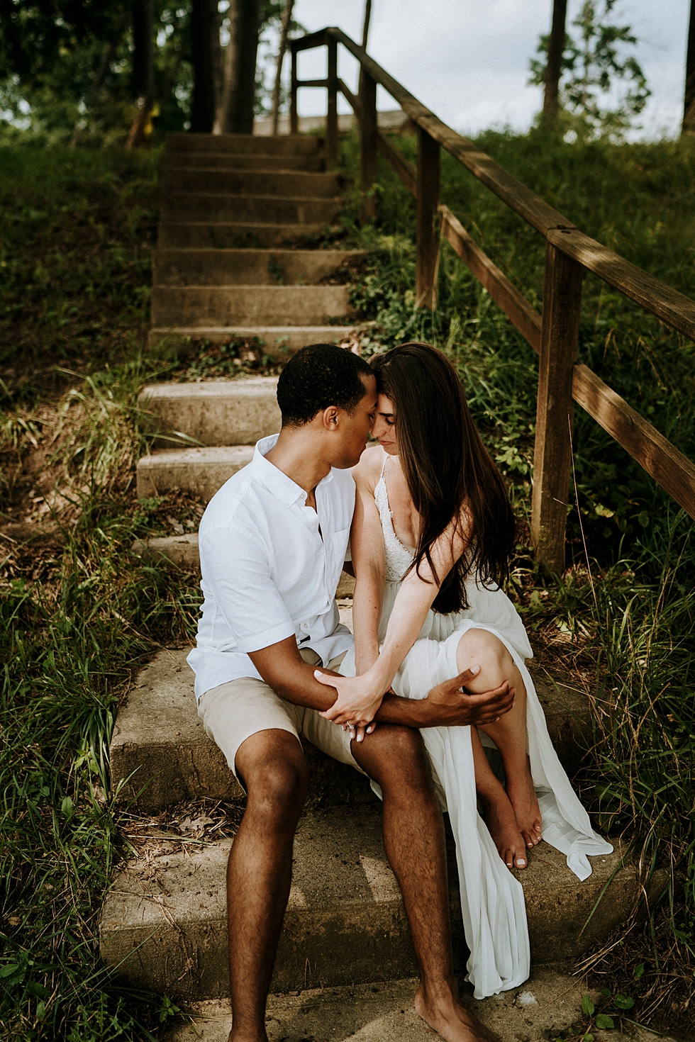  staircase feature engaged couple side by side sitting hand in hand white dress neutral colors intimate setting #engagementphotographer #louisvilleengagementphotographer #kentuckyengagmentphotographer #kentuckyengagments #engagementshoot #loveisinthe