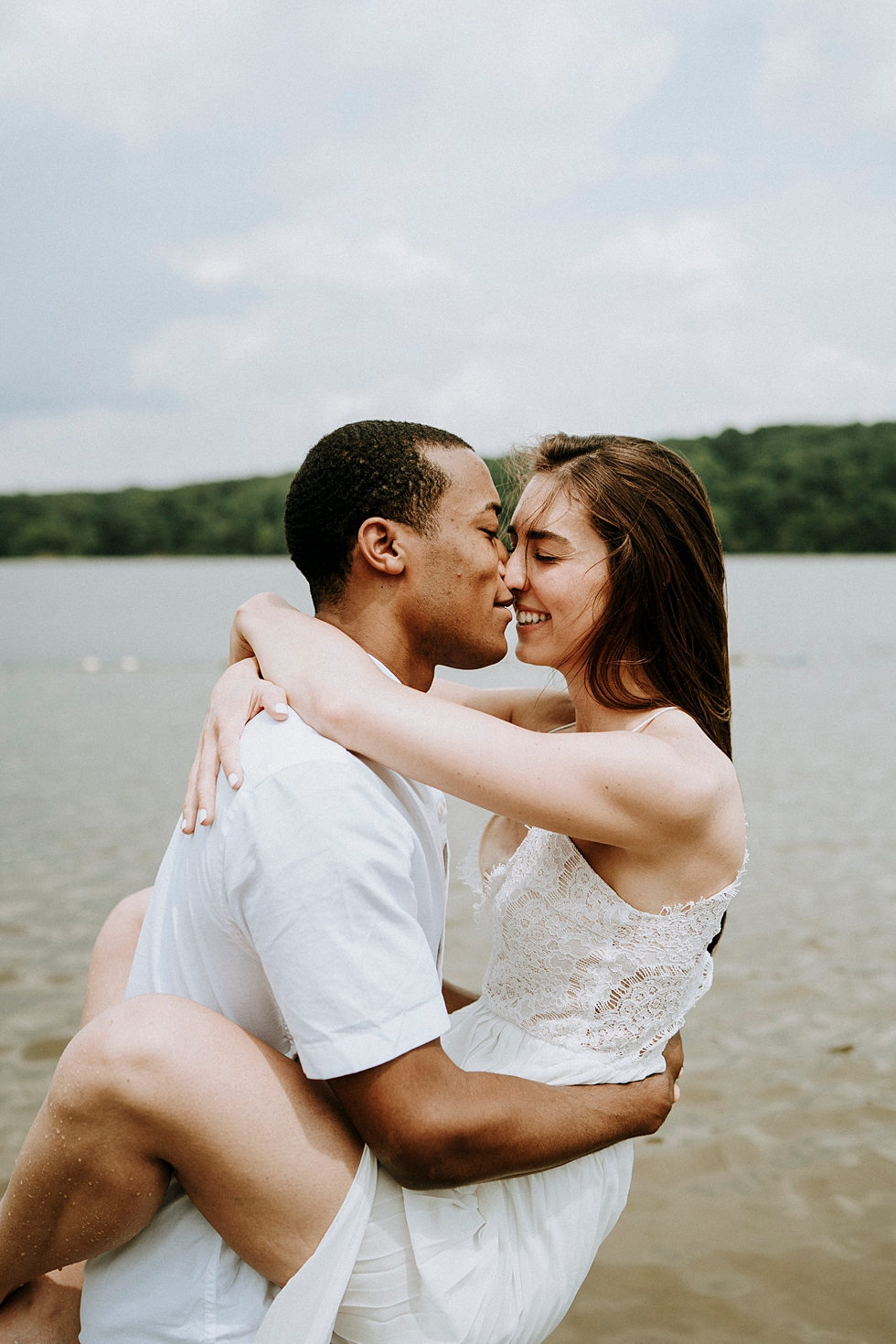  engagement photo session kiss on the beach white sheer dress hug around the neck intimate kiss deam lake background #engagementphotographer #louisvilleengagementphotographer #kentuckyengagmentphotographer #kentuckyengagments #engagementshoot #loveis