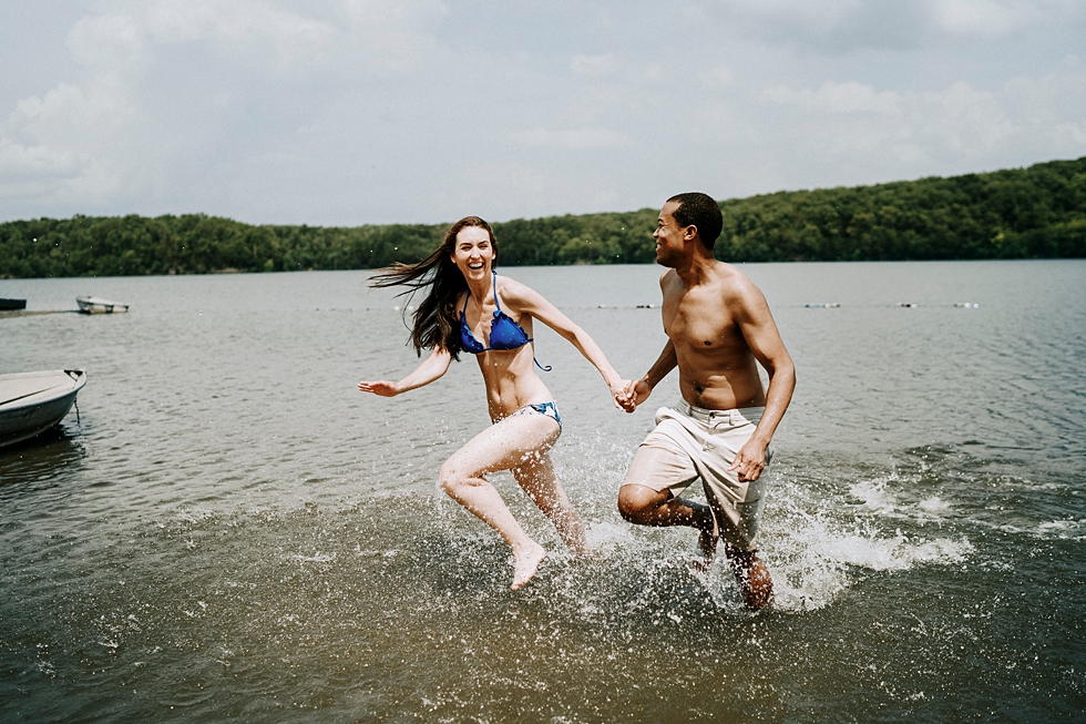  running through the water engagement photo session engagement photographer deam lake swim suits laughter together splashing #engagementphotographer #louisvilleengagementphotographer #kentuckyengagmentphotographer #kentuckyengagments #engagementshoot