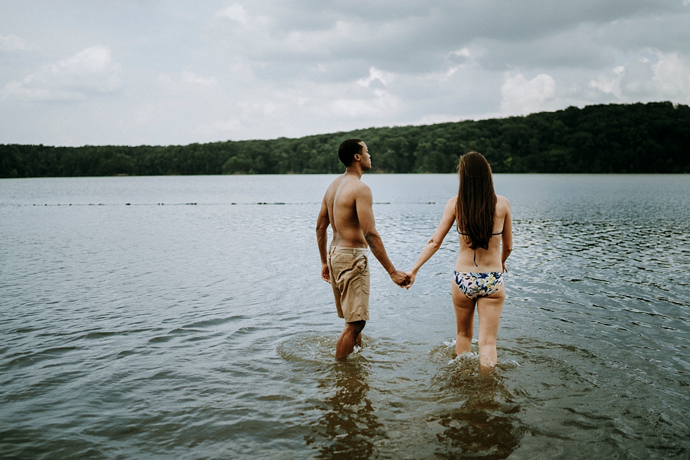  engagement photo session couple walking in deams lake swim suits mountain background water ripples #engagementphotographer #louisvilleengagementphotographer #kentuckyengagmentphotographer #kentuckyengagments #engagementshoot #loveisintheair 