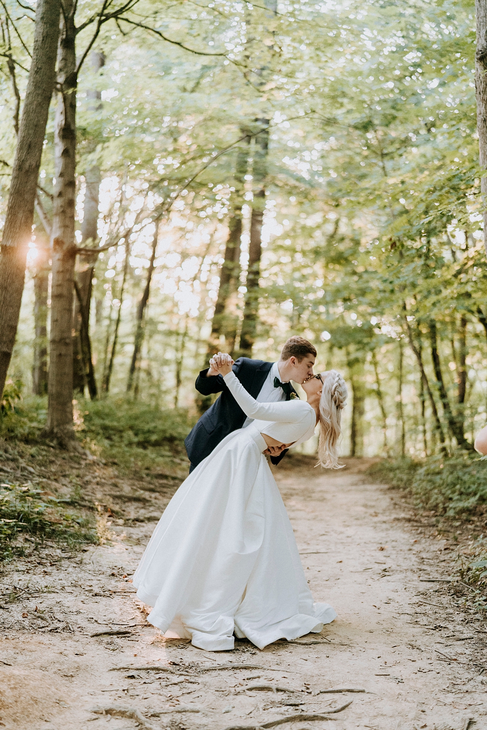  bride and groom kiss in the woods natural lighting at sundown sunset #weddingphotographer #broaduschapel #weddingdaybliss #louisvillephotographer #kentuckyweddingphotographer #weddingsession #photographyanddesignbylauren #weddingceremonyphotographer