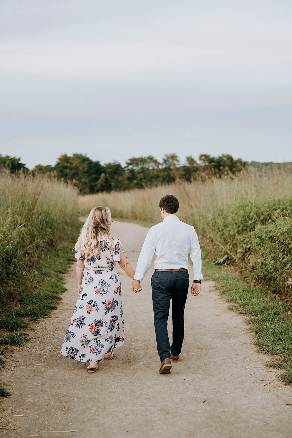  Engaged couple walking away from camera on forest path #engagementphotographer #bernheimforest #engagementgoals #kentuckyengagementphotographer #kentuckyphotographer #engagementsession #photographyanddesignbylauren 