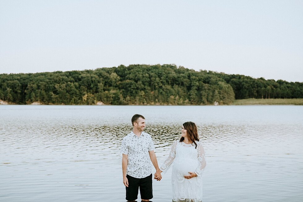  Mom and dad to be holding hands in Deam Lake gazing at each other. #maternitygoals #maternityphotographer #babybump #outdoorphotosession #kentuckyphotographer #indianaphotographer #louisvillephotographer #maternityphotos #expectingababy #miraclebaby