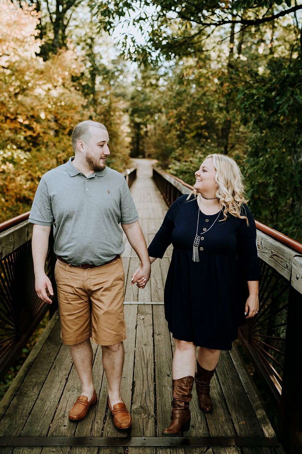  Holding hands on the Bernheim State Forest bridge as an engaged couple #engagementgoals #engagementphotographer #engaged #outdoorengagement #kentuckyphotographer #indianaphotographer #louisvillephotographer #engagementphotos #savethedatephotos #save