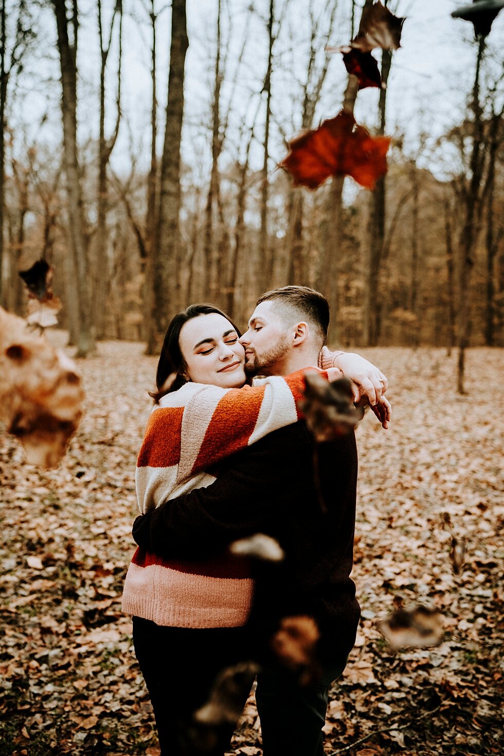  Sweet kisses on the cheek as this couple dances in the fall leaves. #engagementgoals #engagementphotographer #engaged #outdoorengagement #kentuckyphotographer #indianaphotographer #louisvillephotographer #engagementphotos #savethedatephotos #savethe