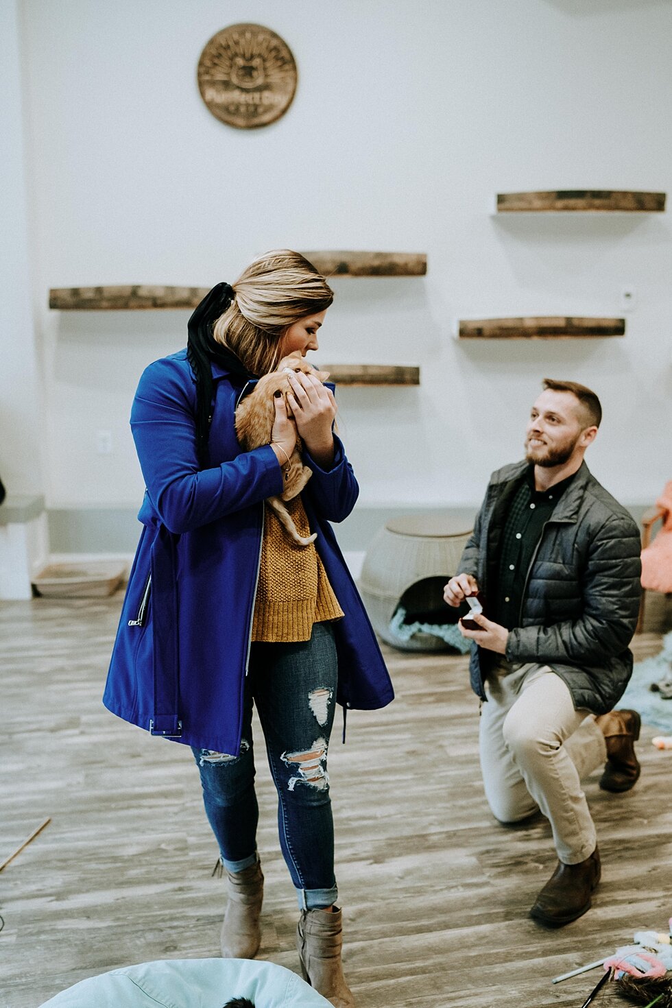 Wearing a royal blue jacket and holding the most precious orange tabby cat, she turned to find her boyfriend down on one knee. #engagementgoals #proposalphotographer #engaged #photographedengagement #kentuckyphotographer #indianaphotographer #louisv