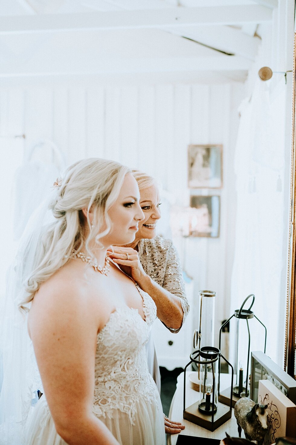  Beautiful bride putting on the final touchese before she becomes a married woman. western wedding midway kentucky vintage barn gold mirror lace wedding gown sweetheart neckline #vintagebarn #westernwedding #midwayky #vintagewedding #horses #thatsdar