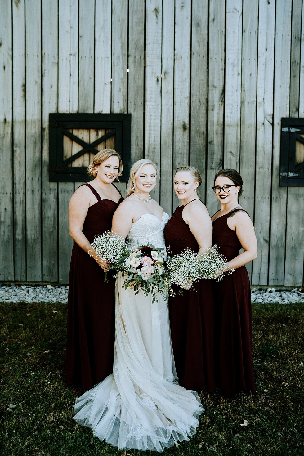  Bride and her beautiful bridesmaids with their wedding bouquets against the vintage barn the bride and groom were married in! #vintagebarn #westernwedding #midwayky #vintagewedding #horses #thatsdarling #weddingday #weddinginspiration #weddingphoto 