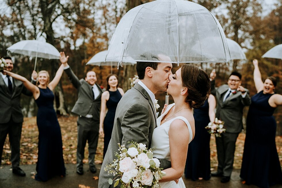  Celebrating bridal party while bride and groom kiss under their umbrella. Rain was good luck on this wedding day! #thatsdarling #weddingday #weddinginspiration #weddingphoto #love #justmarried #midwestphotographer #kywedding #louisville #kentuckywed