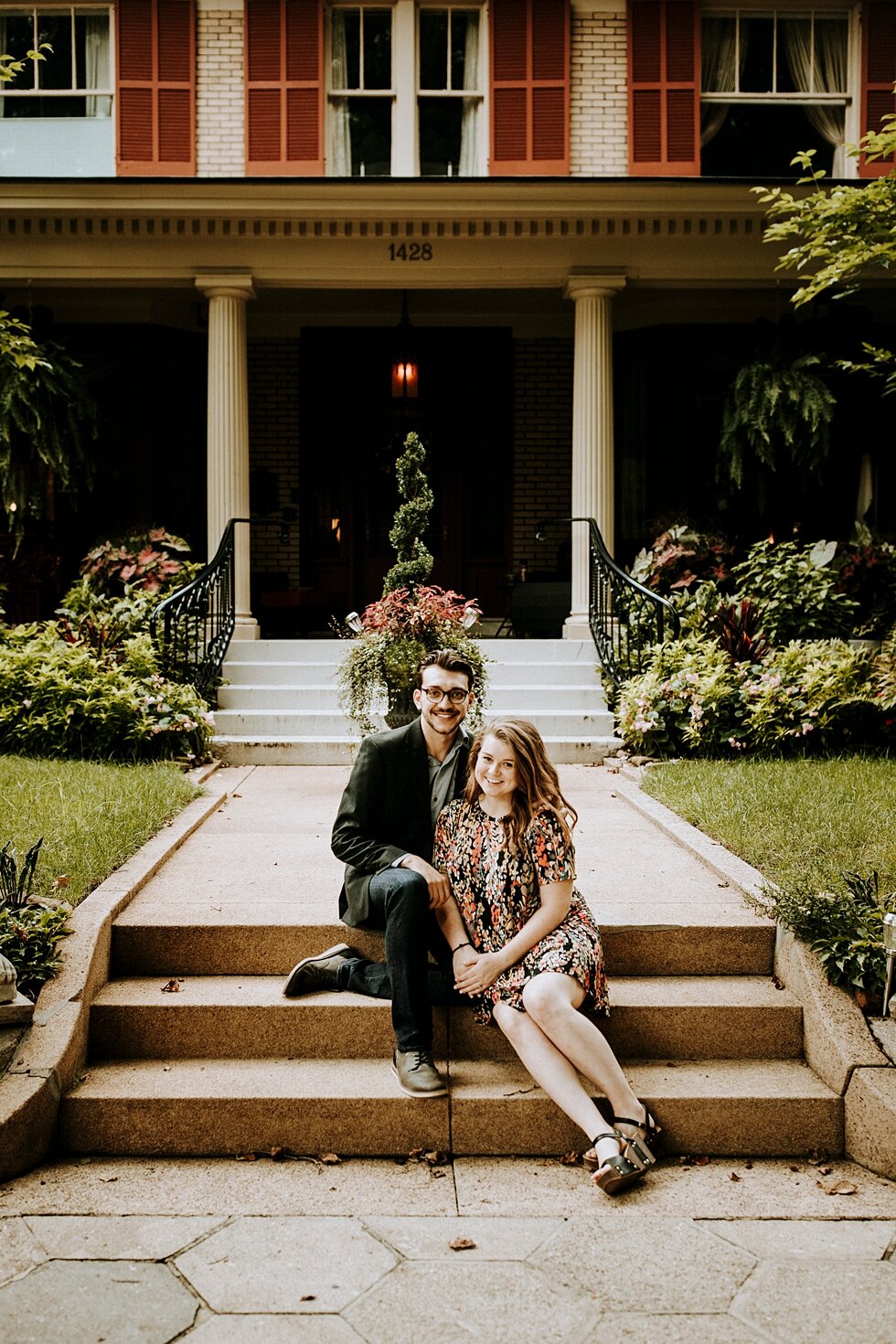 Couple sitting on the steps celebrating their engagement. getting married outdoor session engaged couple together wedding preparation love excited stunning relationship #engagementphotos #midwestphotographer #kywedding #louisville #stjamescourt #sum
