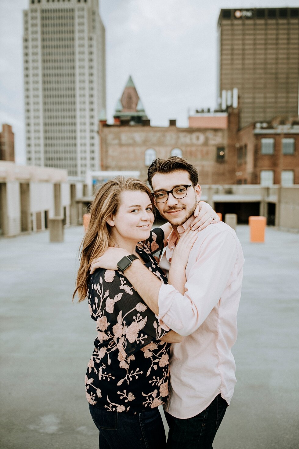  Smiling together this engaged couple celebrated their engagement with a rooftop engagement session and the Louisville skyline in the background. getting married outdoor session engaged couple together wedding preparation love excited stunning relati