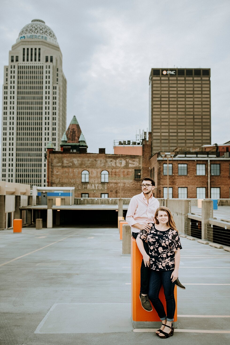  Engaged couple on the rooftop of one of Louisville, Kentucky’s buildings with the skyline in the background. getting married outdoor session engaged couple together wedding preparation love excited stunning relationship #engagementphotos #midwestpho