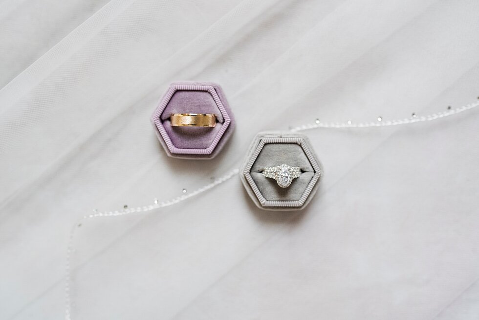  Bride and Grooms rings with purple and grey boxes and white background at The Loft on Spring. wedding ceremony details stunning photography married midwest louisville kentucky #weddingphoto #love #justmarried #midwestphotographer #kywedding #louisvi