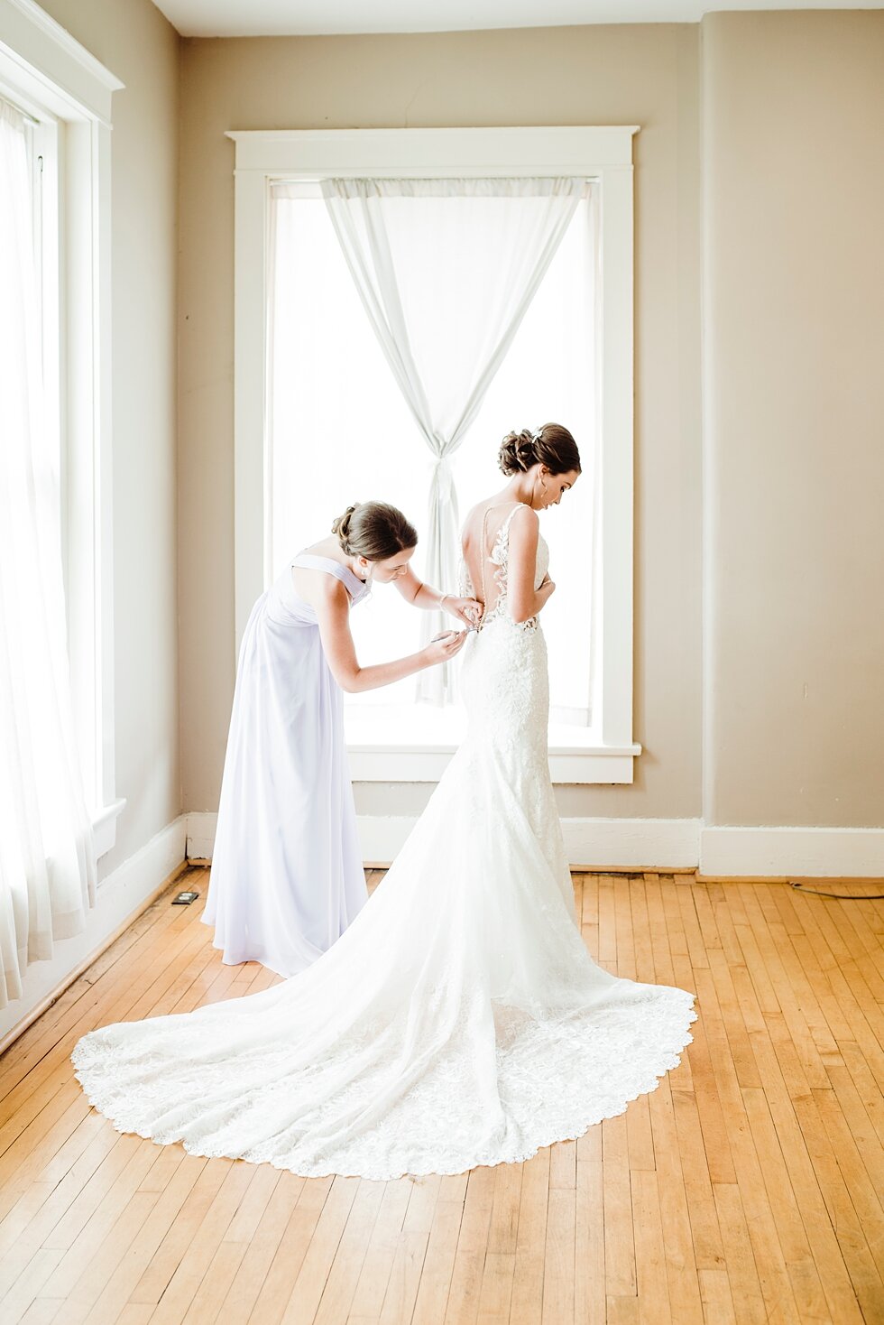  Bride having her dress zipped up by a member of her bridal party in the preparation rooms at The Loft on Spring. wedding ceremony details stunning photography married midwest louisville kentucky #weddingphoto #love #justmarried #midwestphotographer 