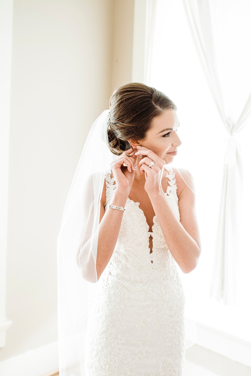  Bride adjusting her earrings and finalizing the last touches of her appearance before she walks down the aisle. wedding ceremony details stunning photography married midwest louisville kentucky #weddingphoto #love #justmarried #midwestphotographer #