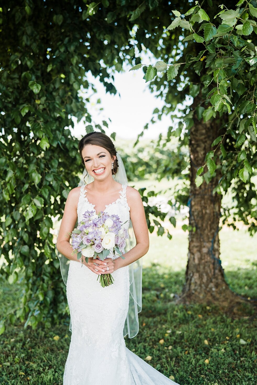  Bridal photos with stunning greenery in the background of the bride smiling and holding her lavender wedding bouquet. wedding ceremony details stunning photography married midwest louisville kentucky #weddingphoto #love #justmarried #midwestphotogra