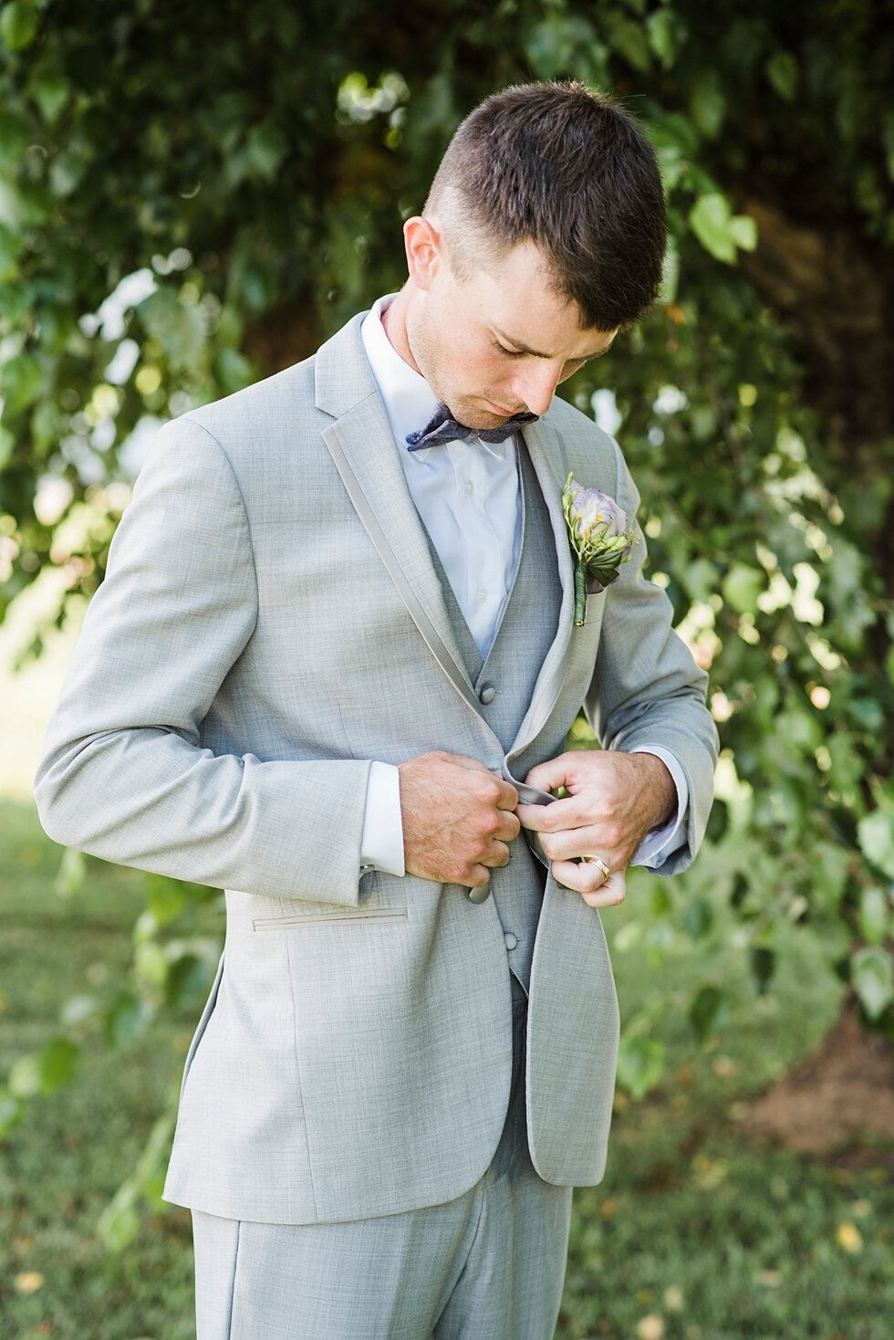  Groom adjusting jacket on his wedding day with greenery in the background as he awaits the arrival of his stunning bride and soon to be wife. #thatsdarling #weddingday #weddinginspiration #weddingphoto #love #justmarried #midwestphotographer #kywedd