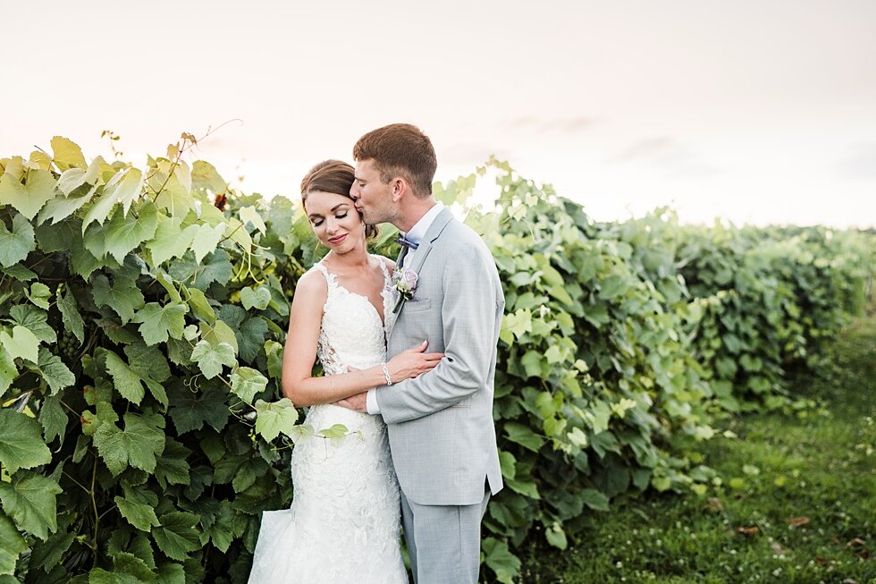  Groom kisses his sweet new wife on the cheek as they have portrait photos taken at Huber Winery in Louisville, Kentucky. wedding ceremony details stunning photography married midwest louisville kentucky #weddingphoto #love #justmarried #midwestphoto