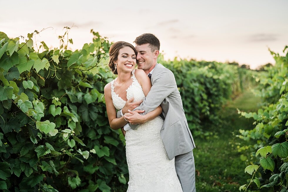  Groom embracing his new wife in the Huber Winery orchards after they join their lives together as husband and wife. wedding ceremony details stunning photography married midwest louisville kentucky #weddingphoto #love #justmarried #midwestphotograph