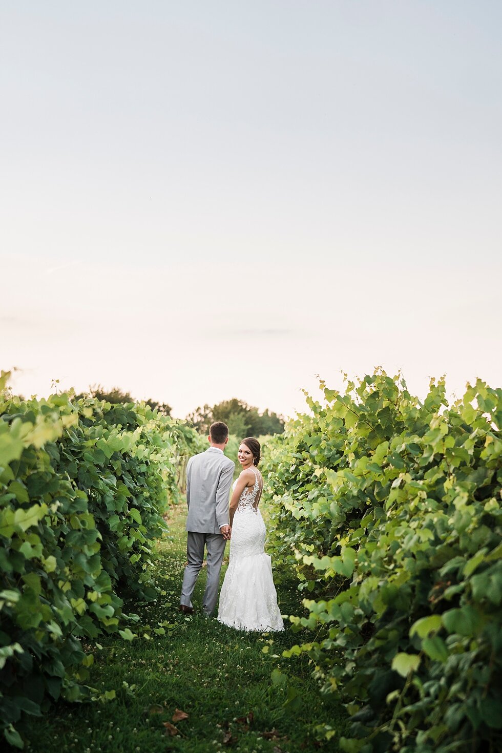  Bride and groom walking together in the Huber Winery orchard after their wedding ceremony. wedding ceremony details stunning photography married midwest louisville kentucky #weddingphoto #love #justmarried #midwestphotographer #kywedding #louisville