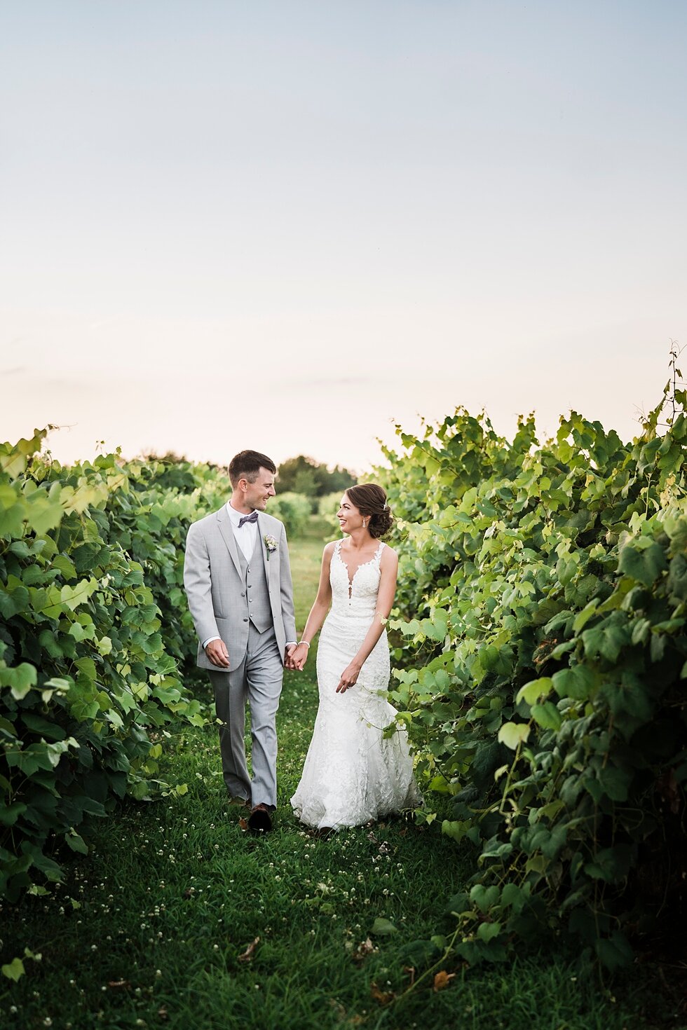  Bride and groom walking together in a wine orchard as they gaze into each others eyes. wedding ceremony details stunning photography married midwest louisville kentucky #weddingphoto #love #justmarried #midwestphotographer #kywedding #louisville #ke