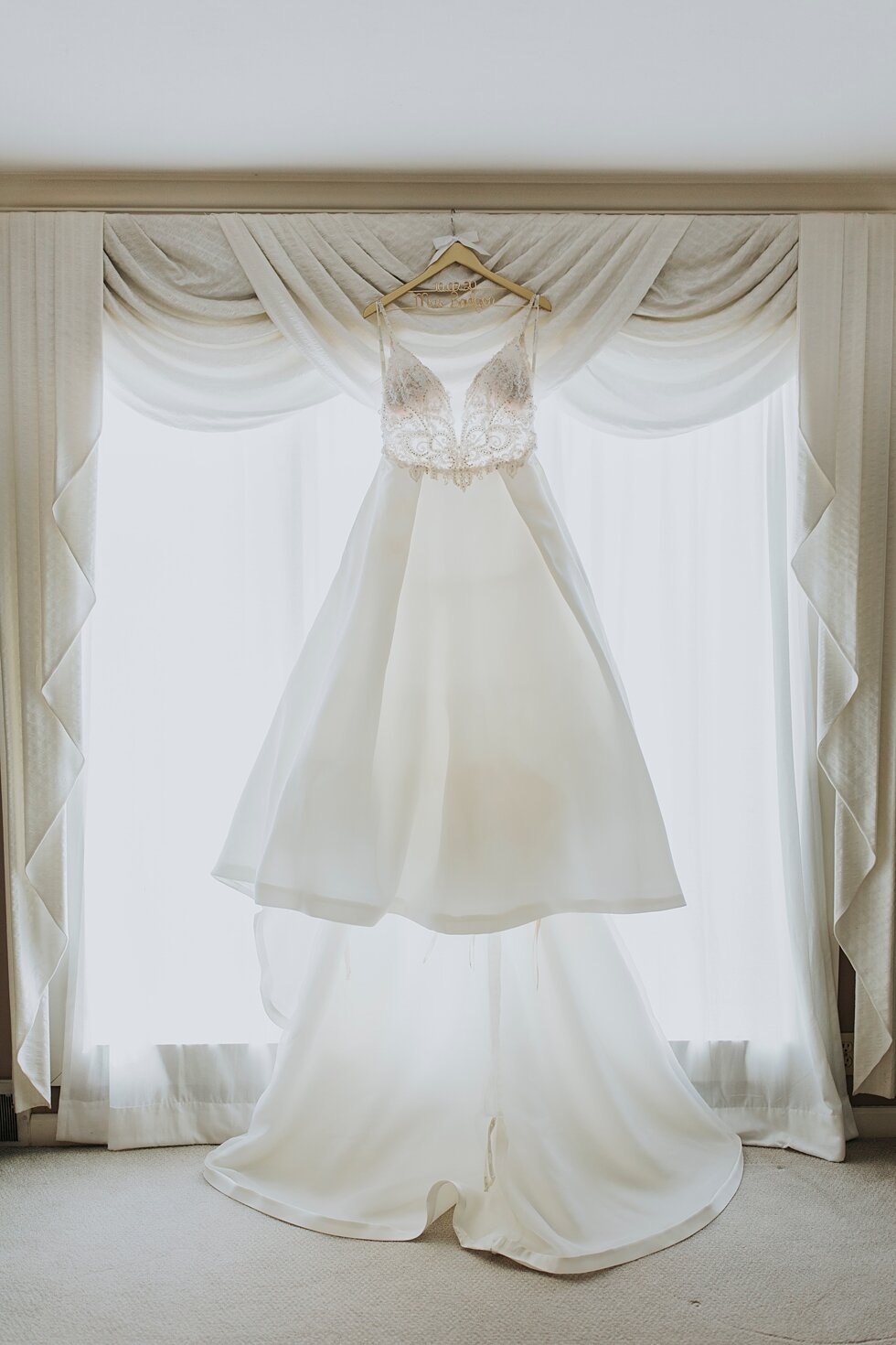Wedding dress hanging in window at hubers bride suite #thatsdarling #weddingday #weddinginspiration #weddingphoto #love #justmarried #midwestphotographer #kywedding #louisville #kentuckywedding #louisvillekyweddingphotographer #weddingbliss #weddi