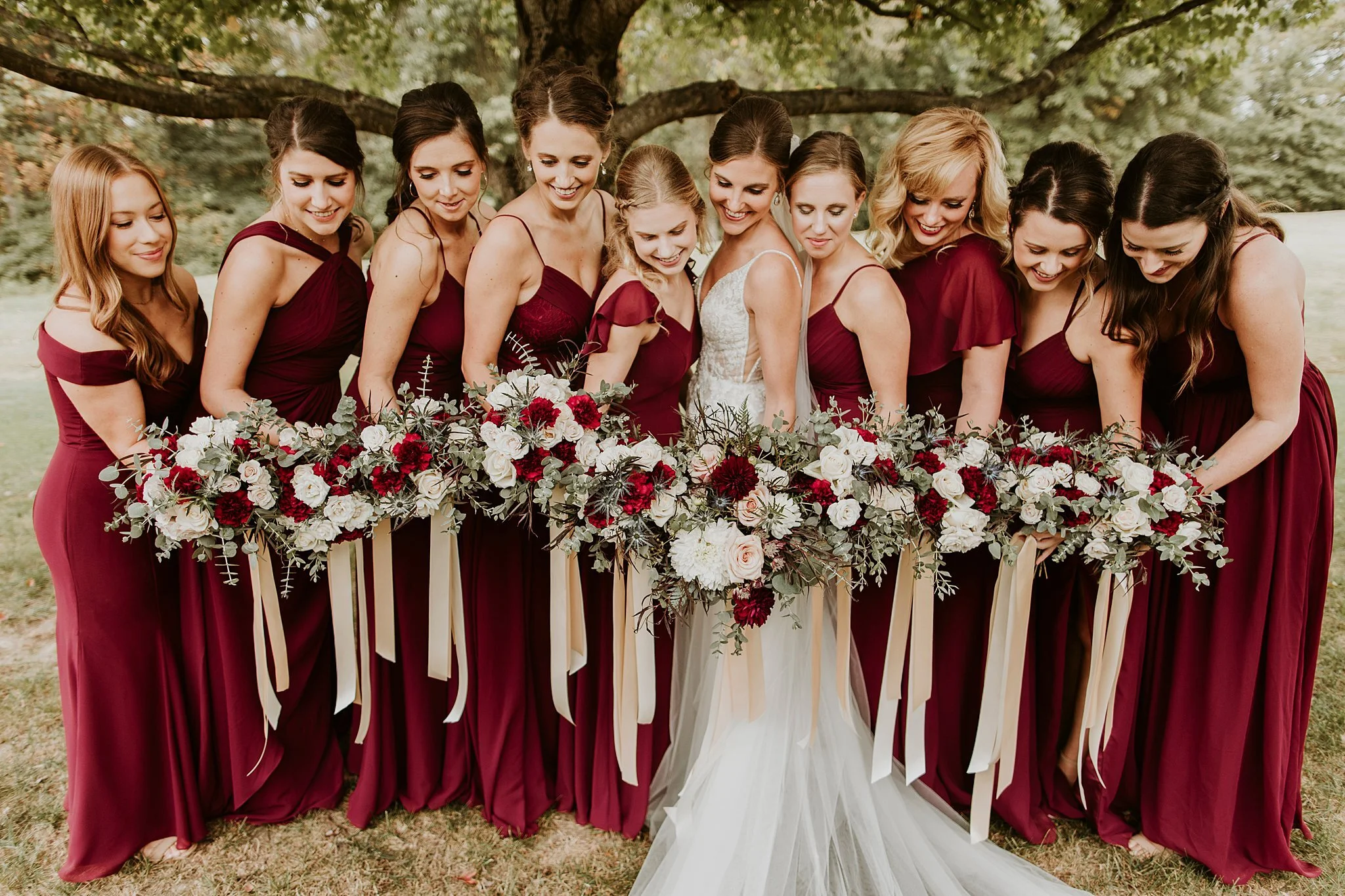 Bride and bridesmaids in maroon dresses #thatsdarling #weddingday #weddinginspiration #weddingphoto #love #justmarried #midwestphotographer #kywedding #louisville #kentuckywedding #louisvillekyweddingphotographer #weddingbliss #weddingformals #love