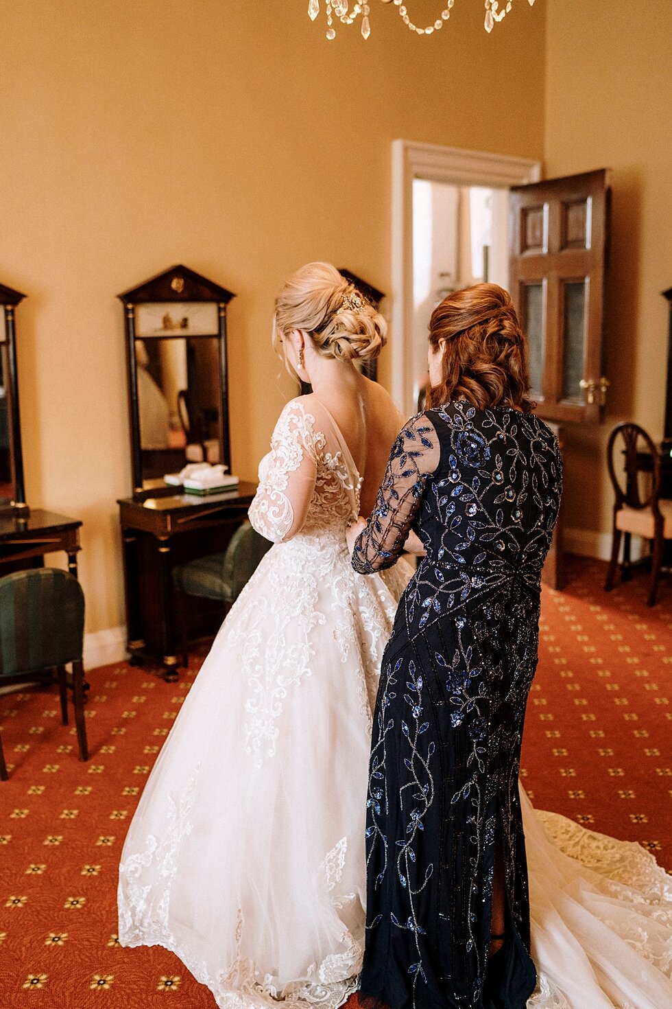  The mother of the bride put the finishing touches on the bride as they finished getting ready in the Bride’s room just before the wedding began. Brisk February winter wedding Pendennis Club Louisville, Kentucky southern wedding bride and groom caref