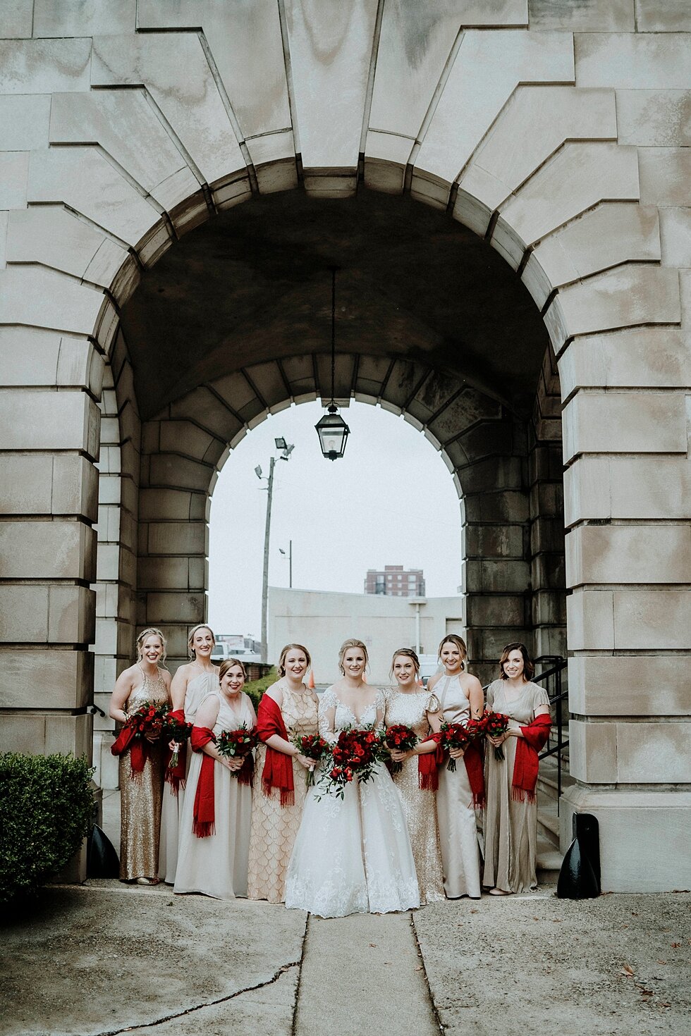  Bright and vibrant red radiated from the hands of all the brides bridal party as they clung to their stunning bouquets. Brisk February winter wedding Pendennis Club Louisville, Kentucky southern wedding bride and groom carefree wedding breathtaking 