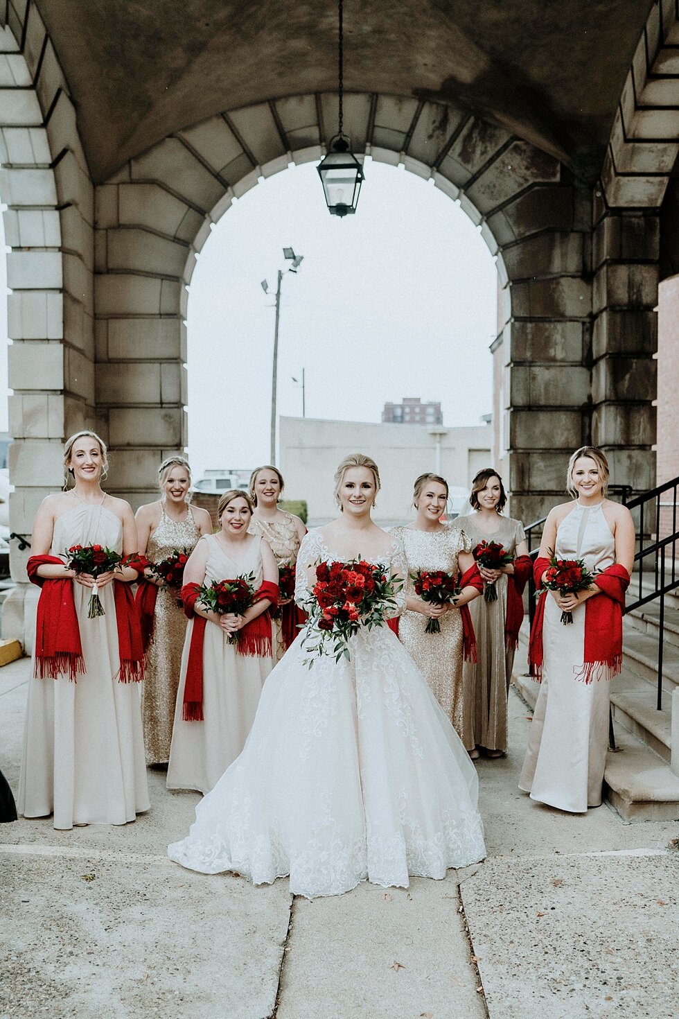  Pendennis Club winter wedding in Lousiville, Kentucky with the stunning bridesmaids and bride in all white with splashes of red with their bridal bouquets and scarves. Brisk February winter wedding Pendennis Club Louisville, Kentucky southern weddin