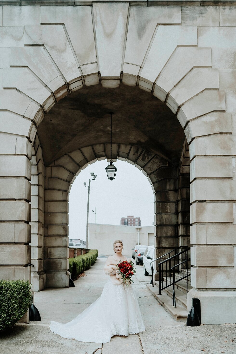  Breathtaking bride standing in the arch of the Pendennis Club courtyard on her wedding day. Brisk February winter wedding Pendennis Club Louisville, Kentucky southern wedding bride and groom carefree wedding breathtaking national register of histori